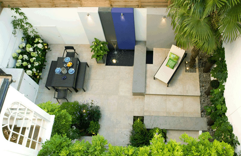 16 Inspirational Backyard Landscape Designs As Seen From Above // More patio-like than backyard-like, this space with a water feature, still offers a relaxing place to gather or enjoy the sun solo. #Backyard #YardIdeas #LandscapingIdeas #YardLayout #YardDesign