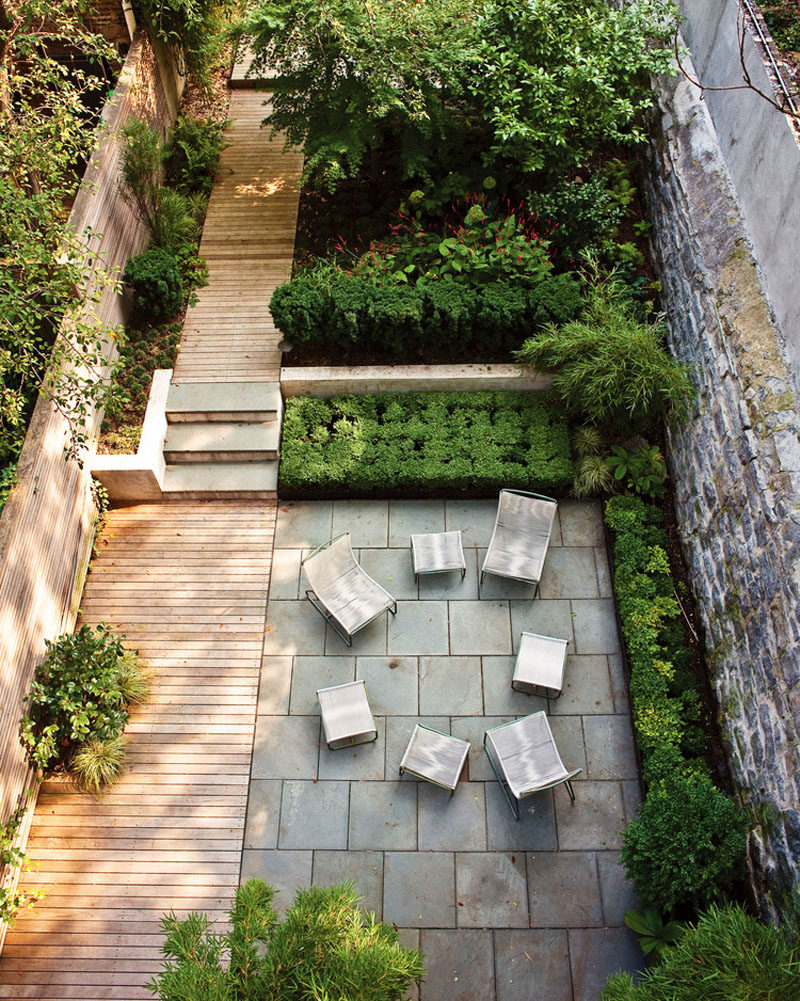 16 Inspirational Backyard Landscape Designs As Seen From Above // A simple, long backyard with a spot to sit together and a garden further back, is connected by a wood plank walkway. #Backyard #YardIdeas #LandscapingIdeas #YardLayout #YardDesign