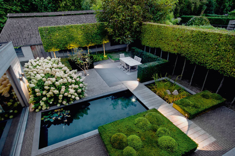 16 Inspirational Backyard Landscape Designs As Seen From Above // This backyard features a natural pool, shaped greenery, a dining space, and an area perfect for sunbathing. #Backyard #YardIdeas #LandscapingIdeas #YardLayout #YardDesign