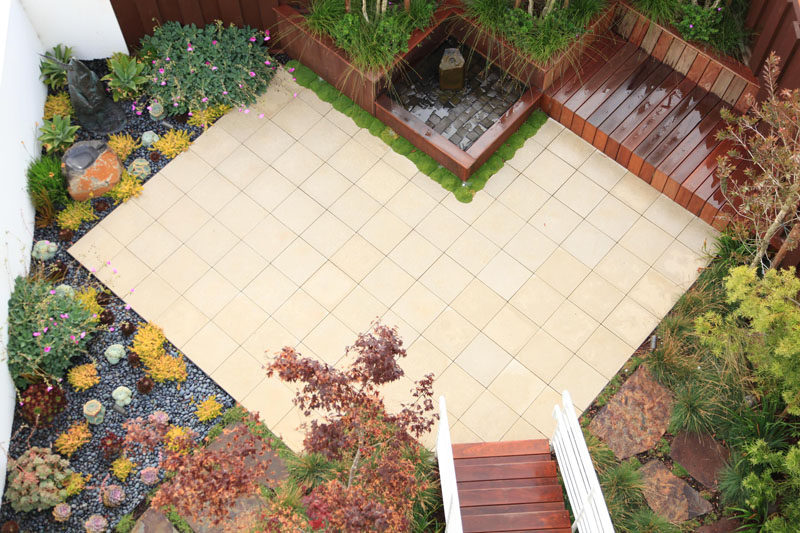 16 Inspirational Backyard Landscape Designs As Seen From Above // This angular backyard patio is surrounded by a succulent garden, a water feature, and seating area. #Backyard #YardIdeas #LandscapingIdeas #YardLayout #YardDesign