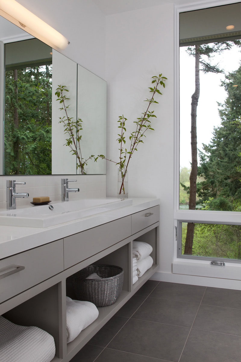 15 Examples of Bathroom Vanities That Have Open Shelving // The large open shelves in this vanity are large enough to house baskets of toiletries as well as multiple fluffy towels.