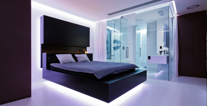 9 Bedrooms With Beds That Feature Hidden Lighting // The lights under the bed in this Romanian apartment can change color to create all sorts of moods.