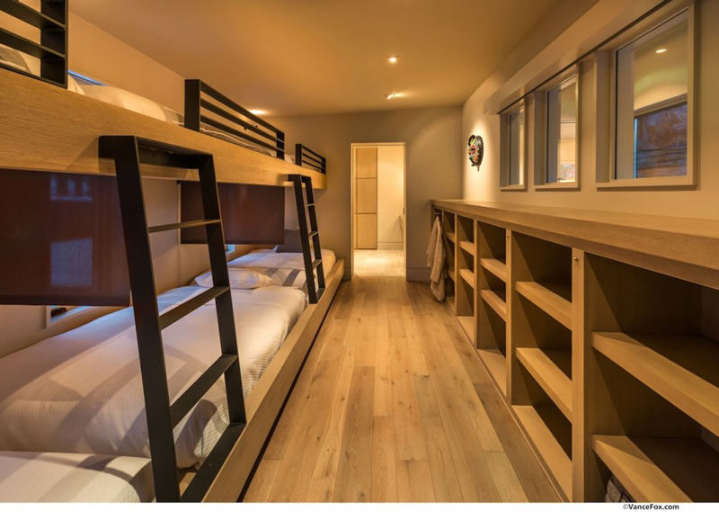 Interior Design Ideas For Sleeping Six People In A Room // These built-in bunk beds in a home designed by Swaback Partners, line the entire side of the room, with storage opposite. The lower beds also have screens to separate them.
