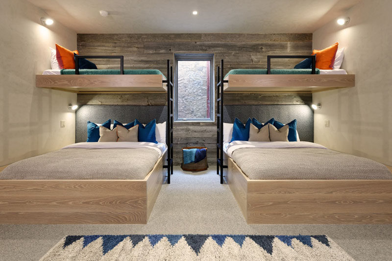 Interior Design Ideas For Sleeping Six People In A Room // These bunk beds are positioned around a window, so not to block the natural light from entering the space. The room, designed by Kaegebein Fine Home Building, has two double beds underneath the top two single bunks, to allow it to comfortably sleep 6.