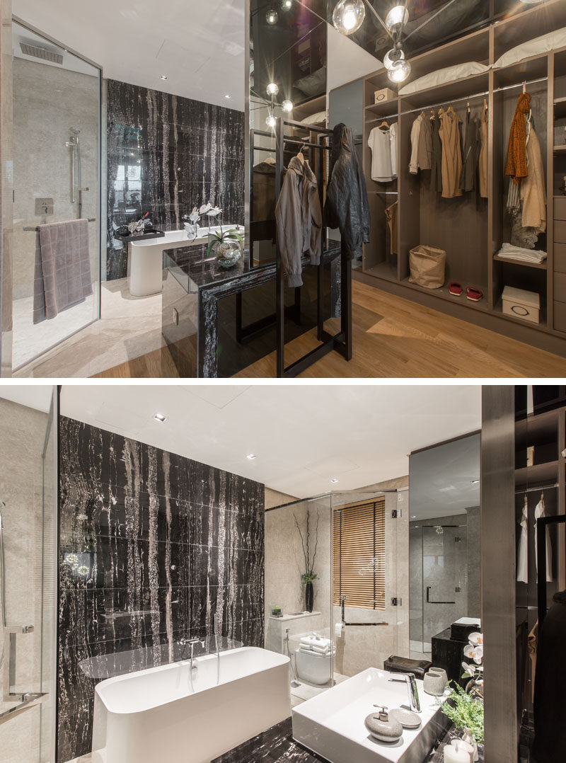 Tucked away behind this walk-in closet is the bathroom, complete with a stone feature wall behind the bath, and a glass enclosed shower tucked into the corner.