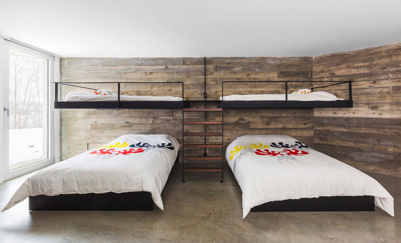 This bedroom is large enough to have two sets of bunk beds, with the upper beds appearing to float above the lower beds.