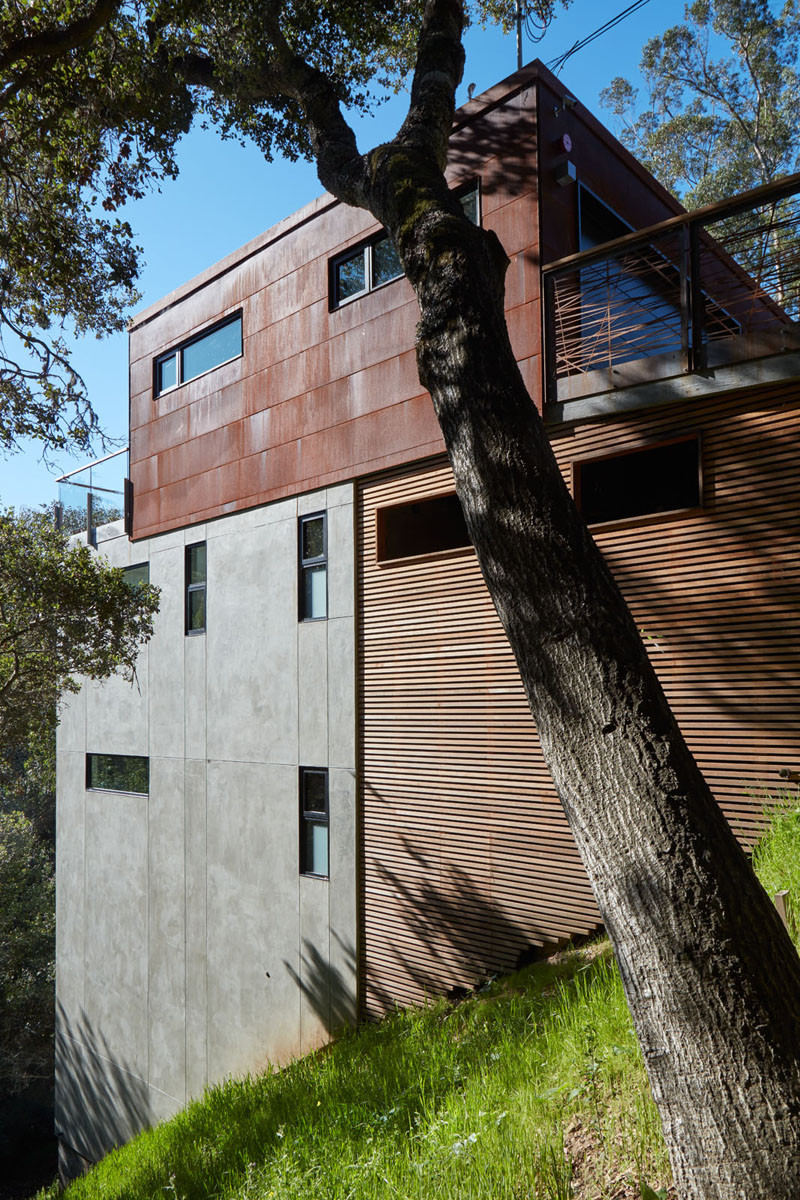 This Home Is Surrounded By Trees And Clad In Corten Steel, Concrete and Wood