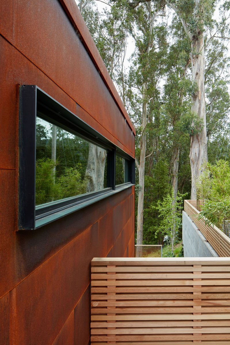 Black window frames contrast the weathering steel siding.