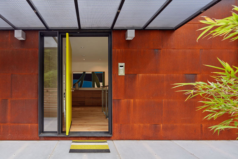 A pivoting bright yellow front door welcomes you to this home.