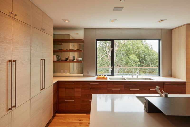 Custom cabinetry has been included in the kitchen, with a mirror helping to make the space appear larger. There's also a custom double stainless steel sink and a second prep sink.