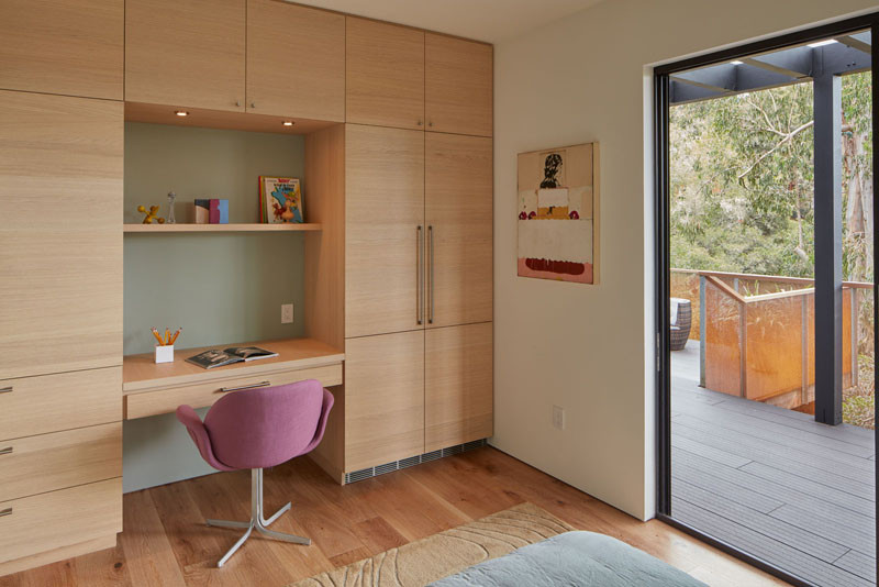 This bedroom has a custom built-in desk and plenty of storage.