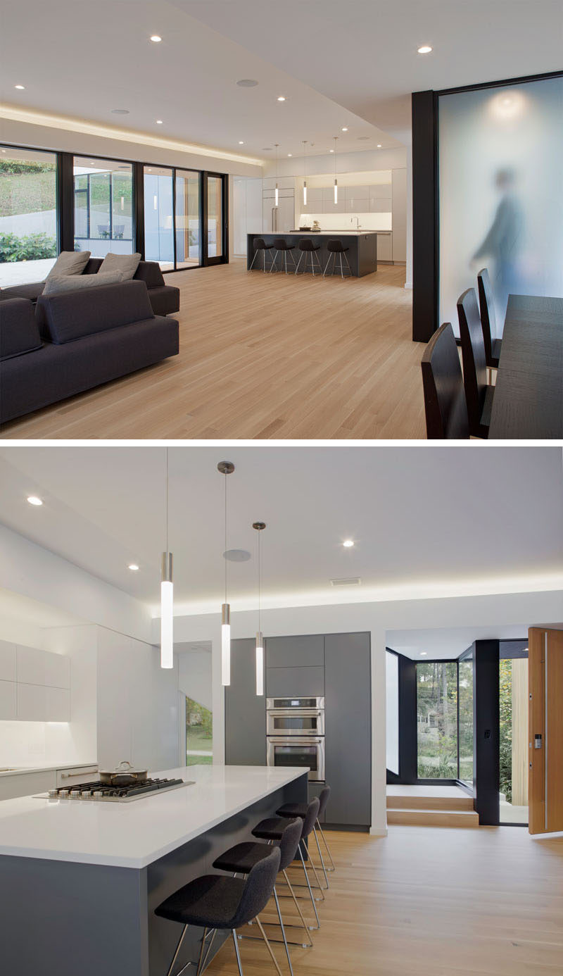 In this grey and white kitchen, there's a large central island that has enough room to comfortably seat four.