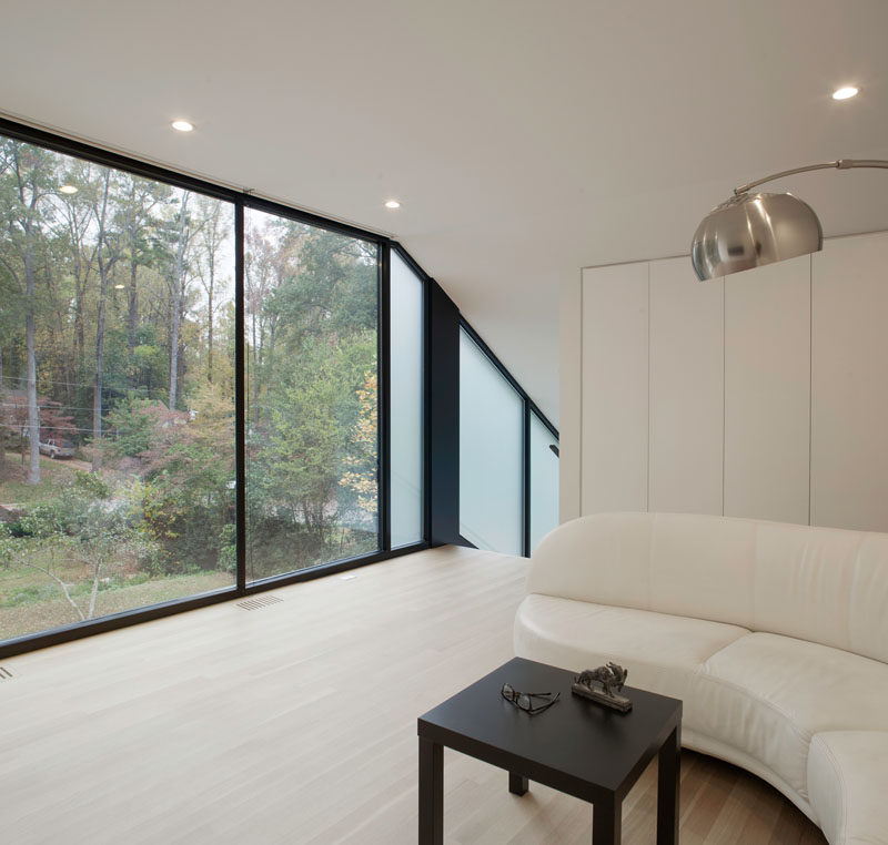 Large floor-to-ceiling windows provide plenty of natural light to the space and views of the surrounding trees