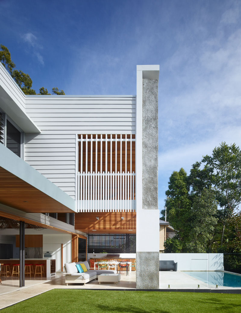 The contemporary Australian home blurs the lines of indoor and outdoor living, with the main floor opening up to the backyard, with a grassed area and swimming pool.