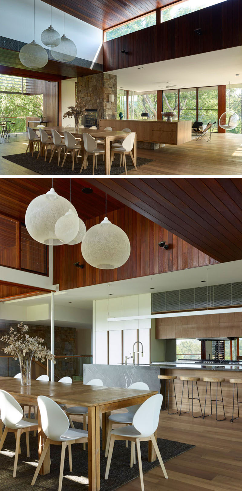 Three white pendant lights and a rug help to anchor the large 12-seater dining table in the open floor plan of this home.