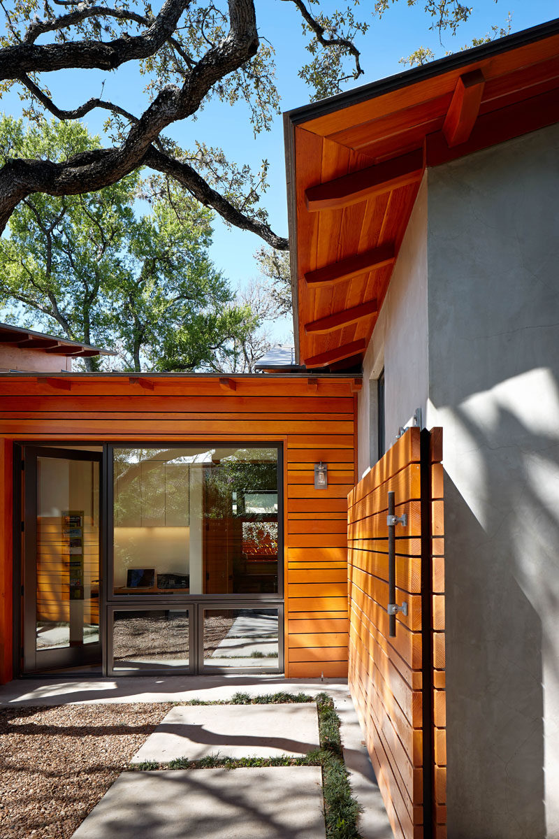 This home has a rolling wooden gate that matches the siding on the house.