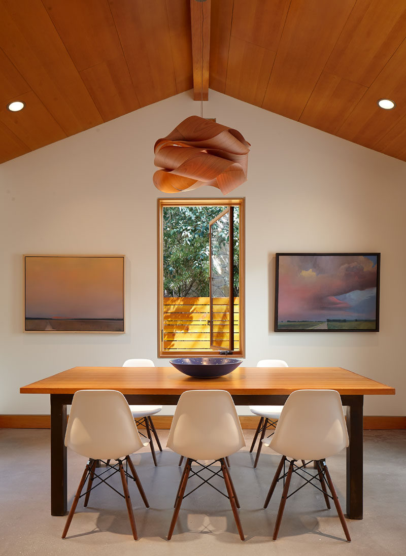 The pendant lamp in this dining room is perfectly positioned in the center of the room and above the window to draw your eye upwards to the ceiling.