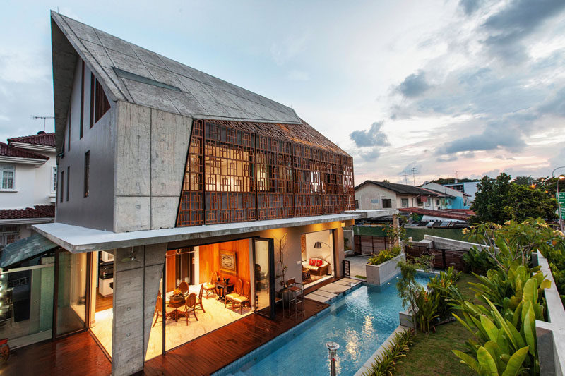 Concrete boundary walls and lush landscaping allow the home owners to have a privacy to enjoy the swimming pool and main floor without being seen from the street.