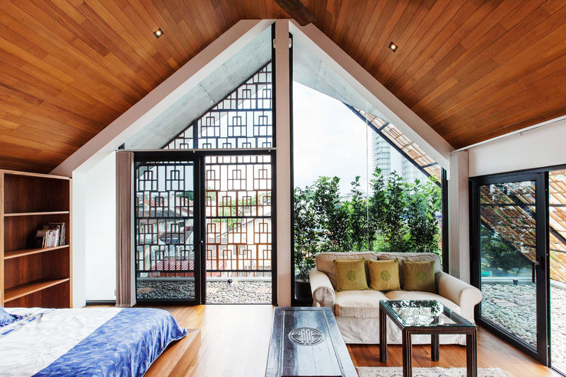 This attic bedroom has a small semi-enclosed balcony and a sitting area.