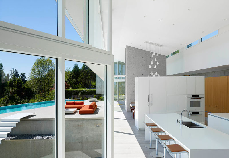 The kitchen in this home is separated from the dining room by a white partition wall full of cabinets.