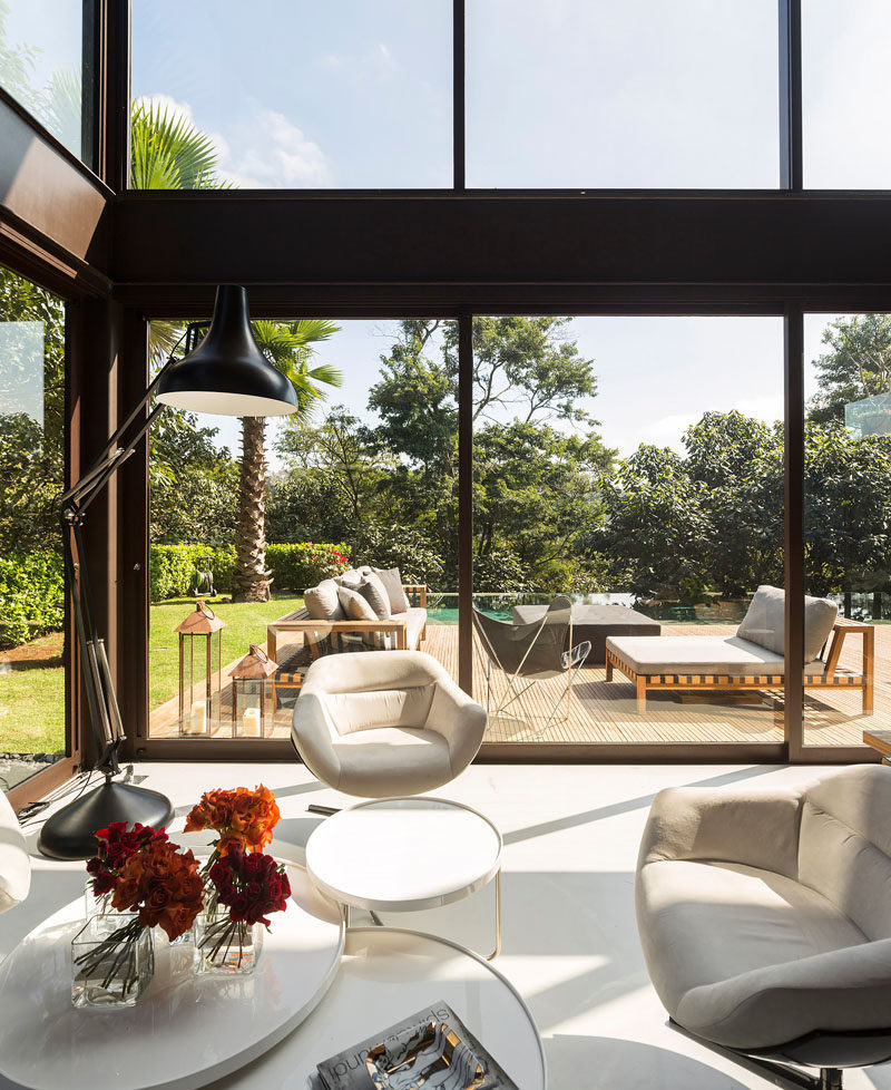 This small sitting area is flooded with natural light from floor-to ceiling windows.