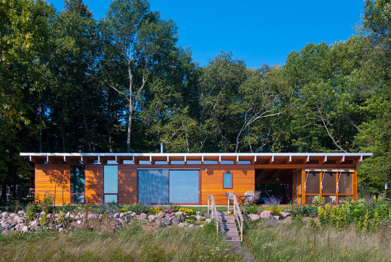 This contemporary wooden beach cottage is located on the shores of Lake Michigan.