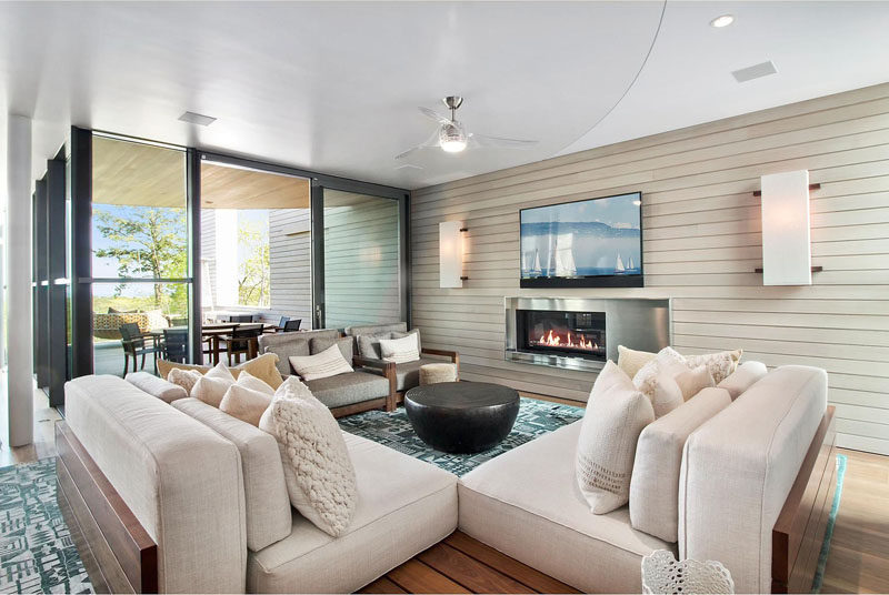 This lounge area has a neutral color palette, with a pop of color in the patterned blue rug.