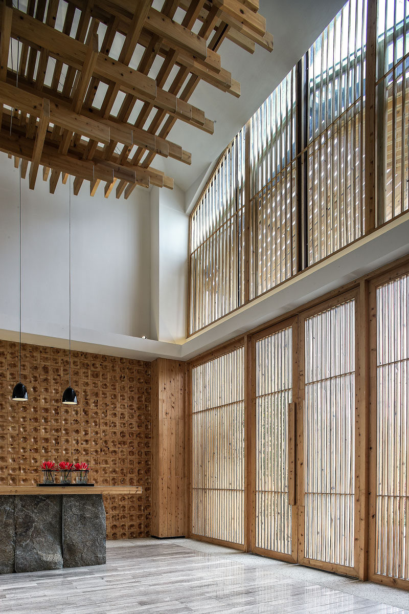 This reception area is flooded with natural light from the large windows, but at the same time, the wooden slats provide a shaded element.