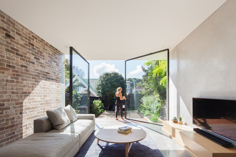 The Back Wall Of This Home Is Made From Two Large Pivoting Glass Doors