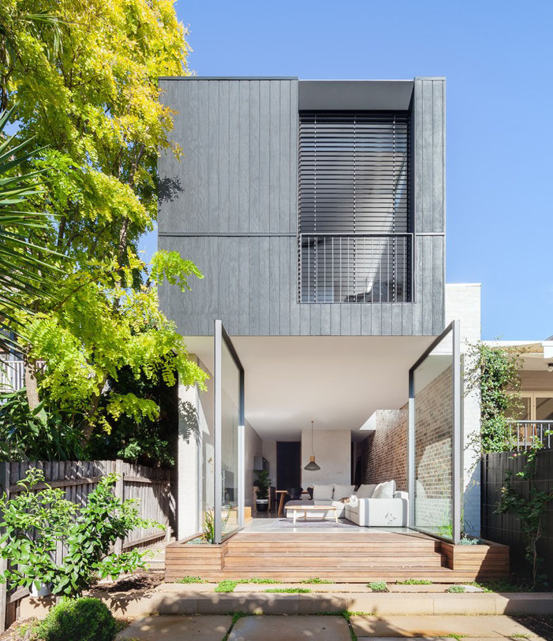 The Back Wall Of This Home Is Made From Two Large Pivoting Glass Doors