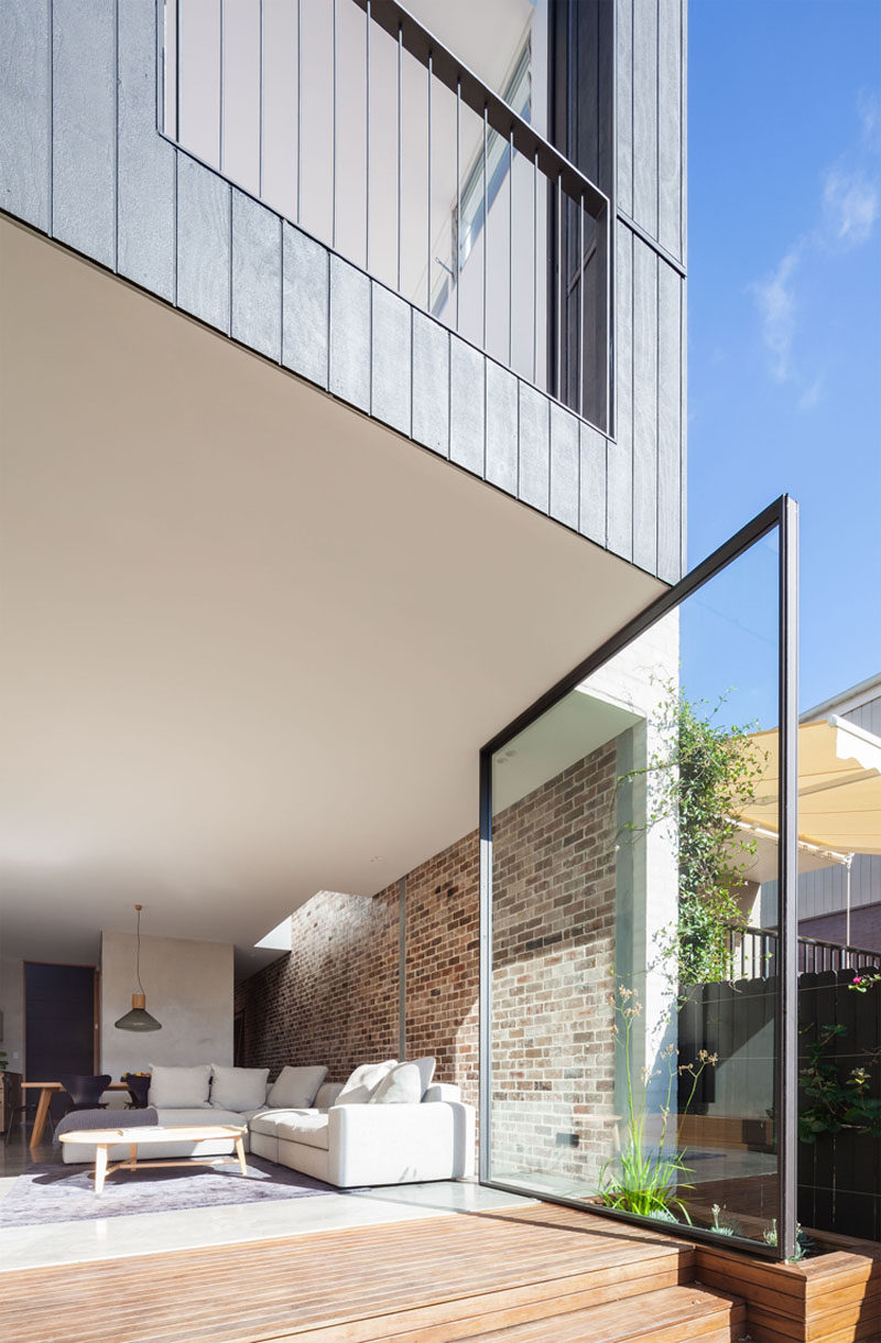 The Back Wall Of This Home Is Made From Two Large Pivoting Glass Doors