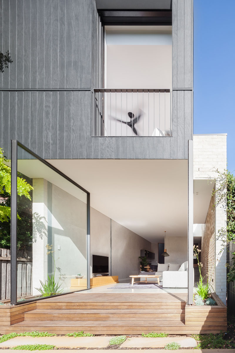 The Back Wall Of This Home Is Made From Two Large Pivoting Glass Doors