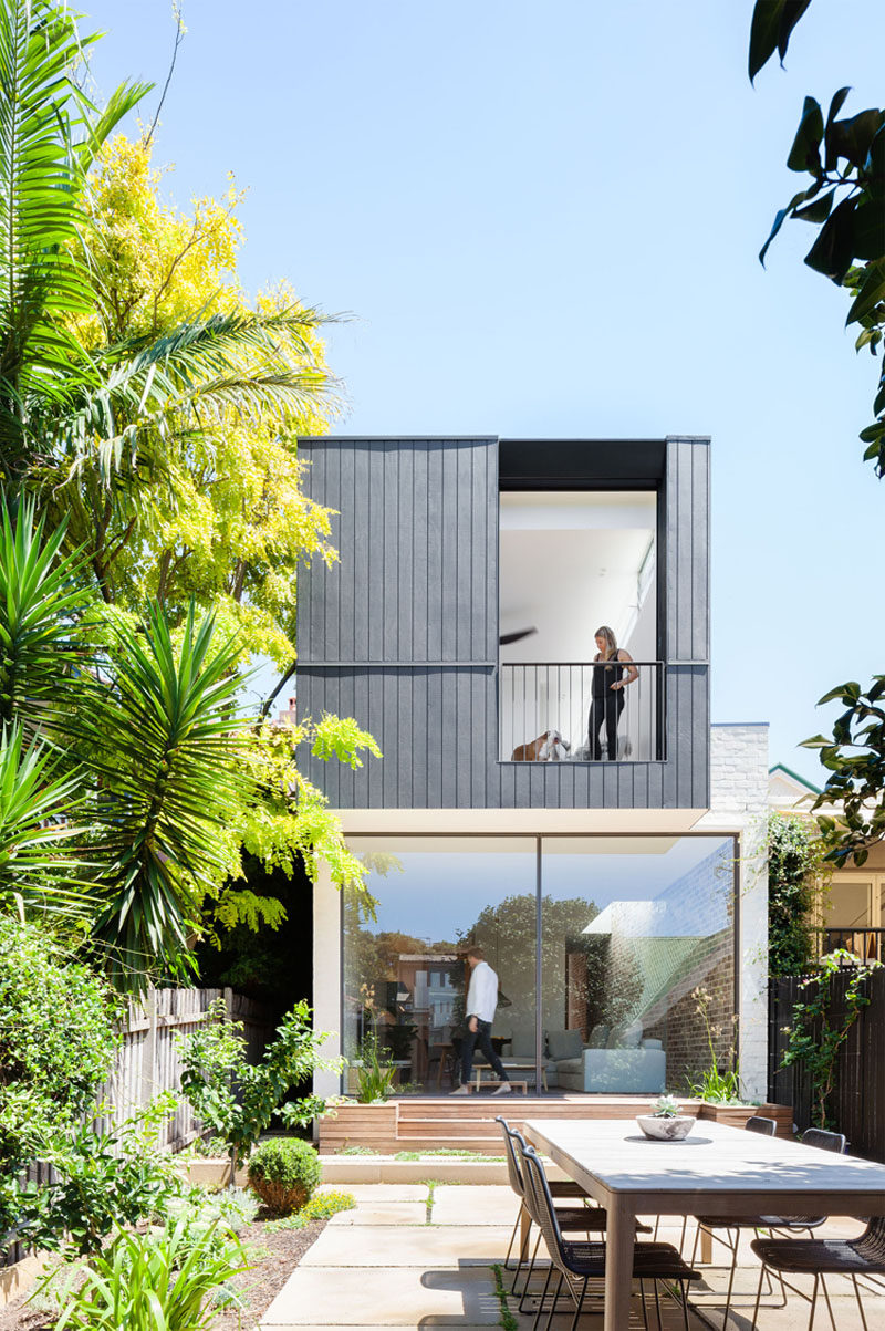 The Back Wall Of This Home Is Made From Two Large Pivoting Glass Doors