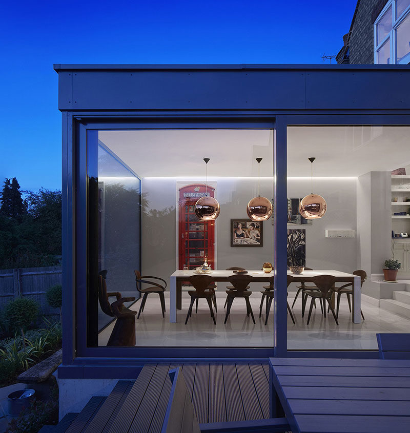 A glass enclosed extension created a dining room with views for this home