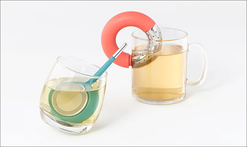 Koma and Torus, are minimalist, brightly colored tea infusers. Koma has a round base with stainless steel-trimmed handle to easily stir the tea.And the brushed steel cover, can easily be opened at the touch of a finger for quick refills. Torus is the donut-shaped tea infuser, and it can be turned into an S-shape, allowing it to cling to any cup. Torus can also be stored on a case, that can hold up to three infusers, and can also be used for dry storage of loose tea.