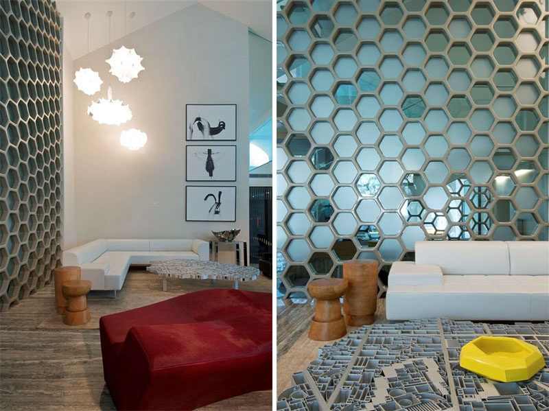 19 Ideas For Using Hexagons In Interior Design And Architecture // This wall of blue glass hexagons separates the living area from the dining area in this family home.