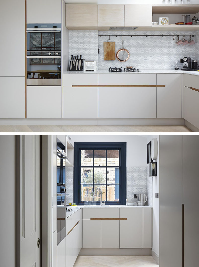 This kitchen has white melamine cabinets with a recessed finger detail made from European oak, to make it easy to open the drawers and cabinets.