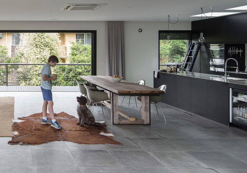 This Matte Black Kitchen Has A Rolling Ladder To Reach The Upper Cabinets