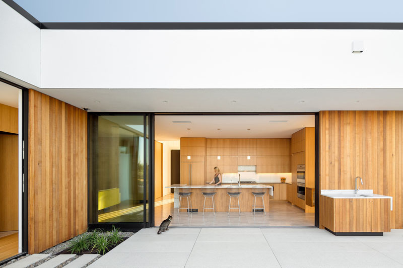 This wooden kitchen has an island large enough to seat four people.