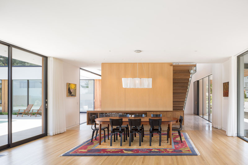 In the dining area, natural light floods the space from the windows on either side of the home.