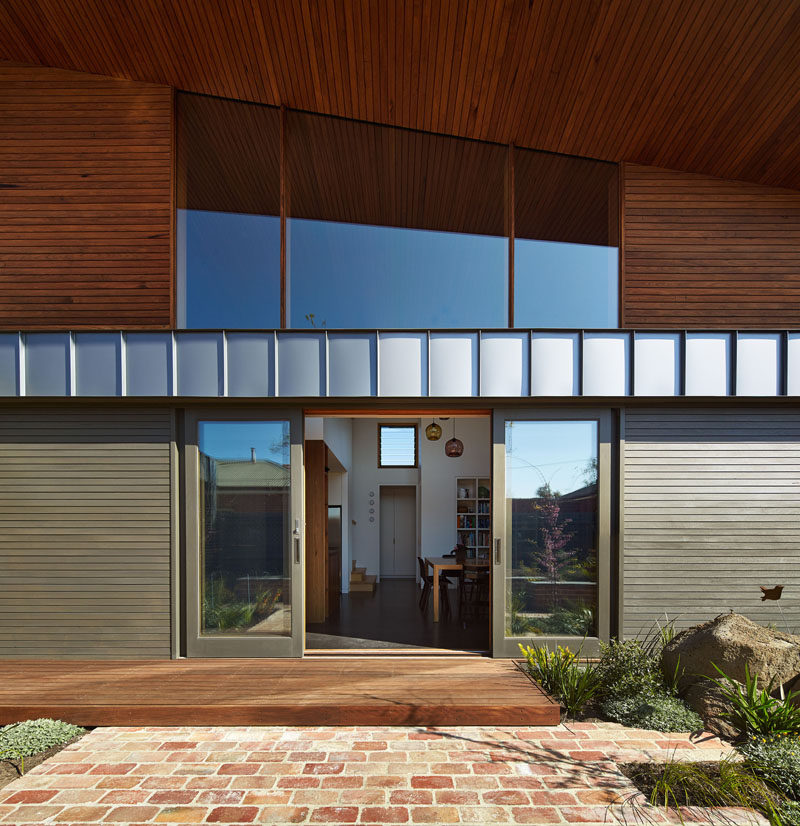 Sliding doors connect the landscaped yard with the interior of this home.