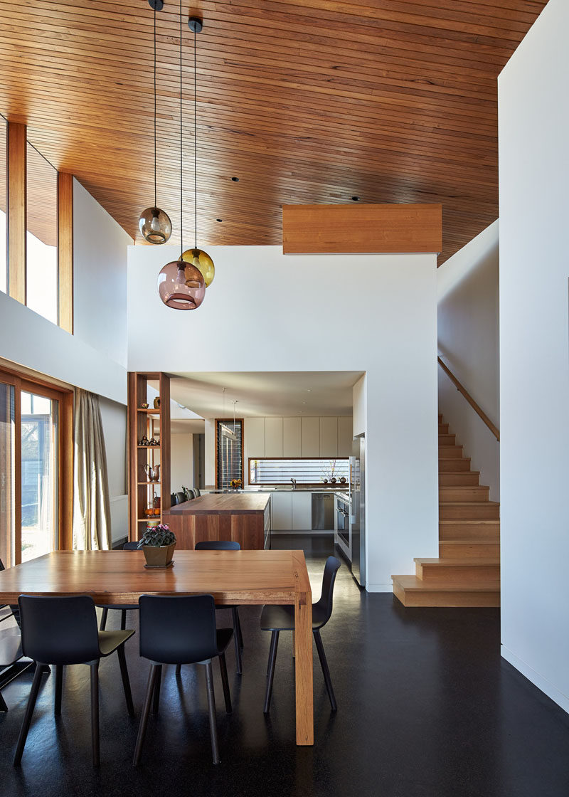 This house extension opens up and becomes double-height, with a wooden ceiling that flows from the inside to the outside.