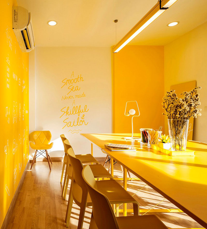 10 Examples Of Monochromatic Interiors // Meetings are made much more cheerful in this yellow office.