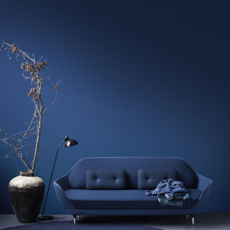 10 Examples Of Monochromatic Interiors // This deep blue wall matches the sofa, blanket and rug.