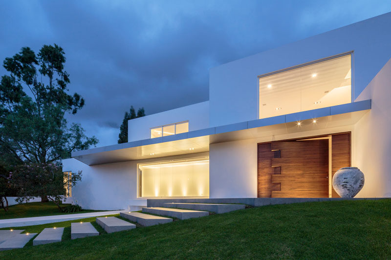 This over-sized wooden pivoting front door definitely makes a statement.