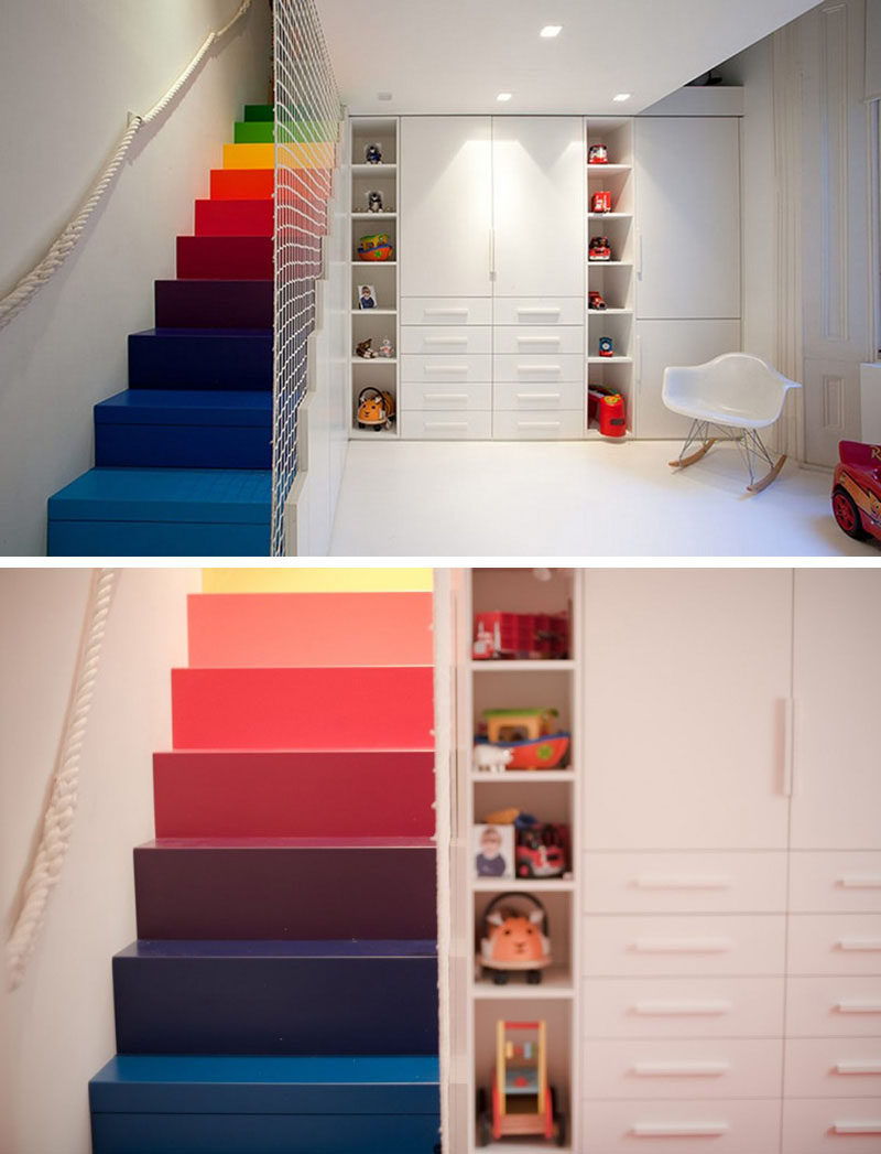 7 Inspiring Examples Of Rainbow Stairs // This all white playroom is brightened up with these rainbow stairs, that have a net safety railing.
