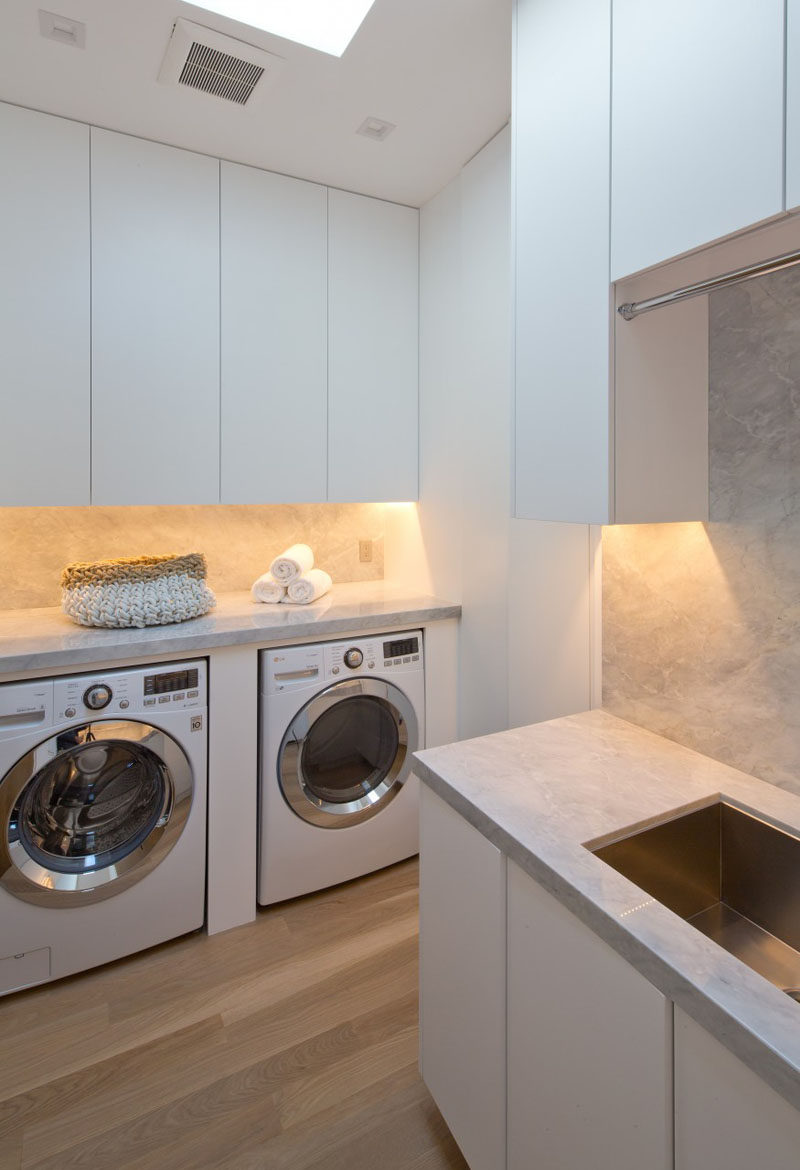 This laundry room is full of cabinets and has a skylight for adding natural light to the room.
