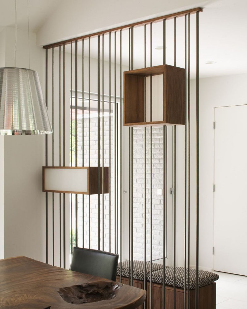 15 Creative Ideas For Room Dividers // This space divider, made of metal rods and suspended boxes, separate the entrance way from the dining area without making either one feel closed off.  #ModernRoomDivider #RoomDivider #InteriorDesign #Interiors