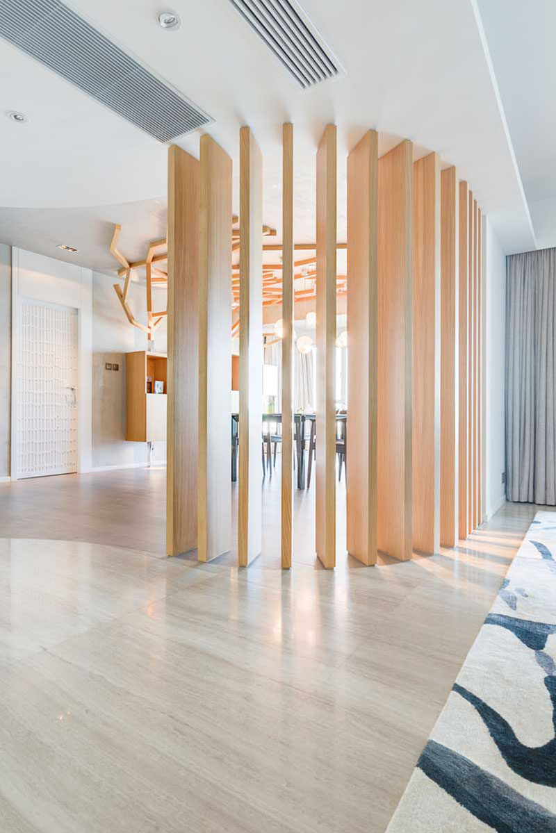 15 Creative Ideas For Room Dividers // This contemporary apartment has lot of elements of nature throughout it, including the wooden space divider between the dining and living areas.  #ModernRoomDivider #RoomDivider #InteriorDesign #Interiors