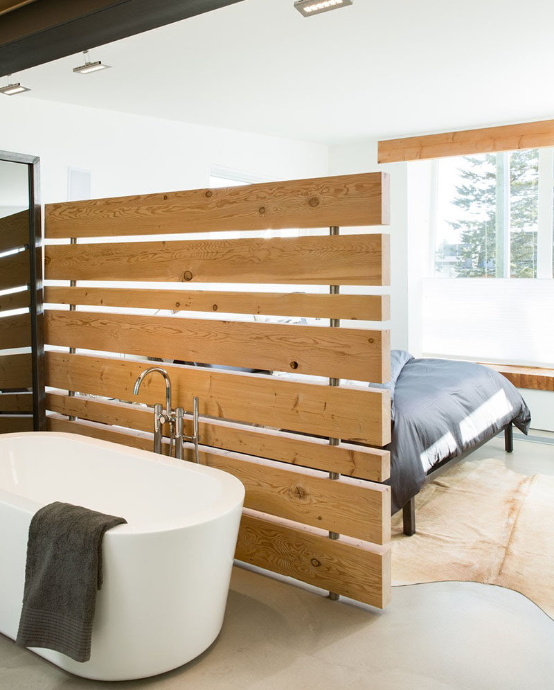 15 Creative Ideas For Room Dividers // A wood panel wall separates the tub from the bed in one of Canada's greenest homes.  #ModernRoomDivider #RoomDivider #InteriorDesign #Interiors